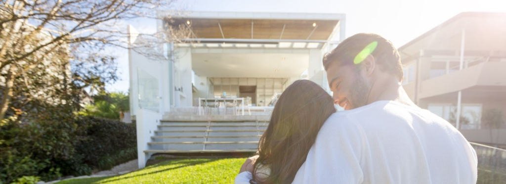 home buyers - Berkshire Hathaway HomeServices Baja Real Estate Home buyer couple infront of new home