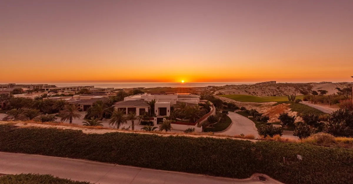 What You Need to Know About Baja Surs Property Market in 2025 - Berkshire Hathaway HomeServices Baja Real Estate Luxury homes in Baja Sur at sunset, overlooking the ocean and surrounding desert landscape