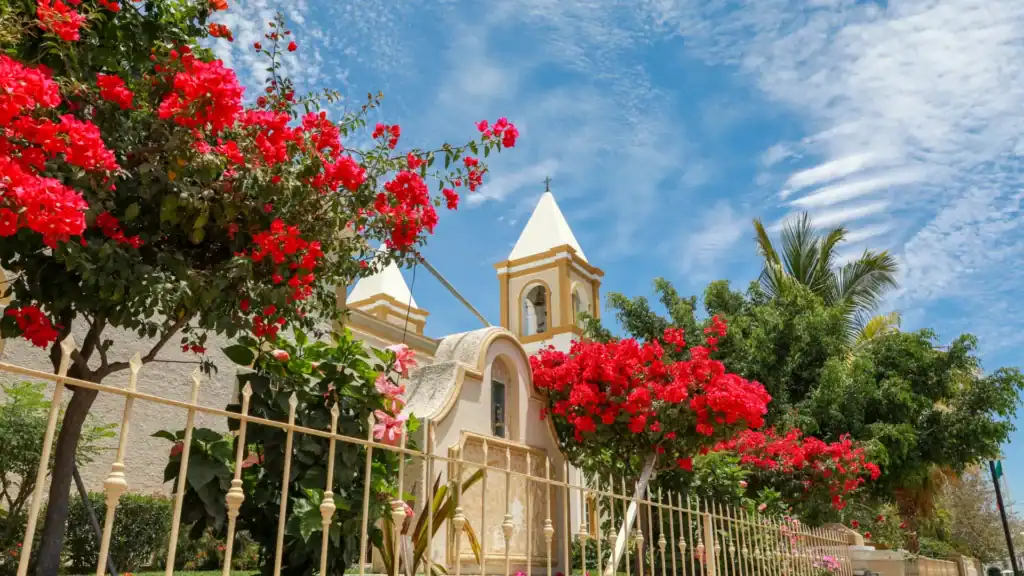Colonial church facade with bougainvillea in bloom in the historic town center of San José del Cabo, Baja California Sur, Mexico.
